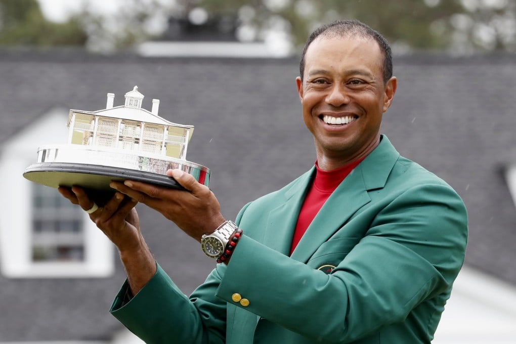 Tiger Woods wields the Masters trophy after his win. Photo: Kyodo
