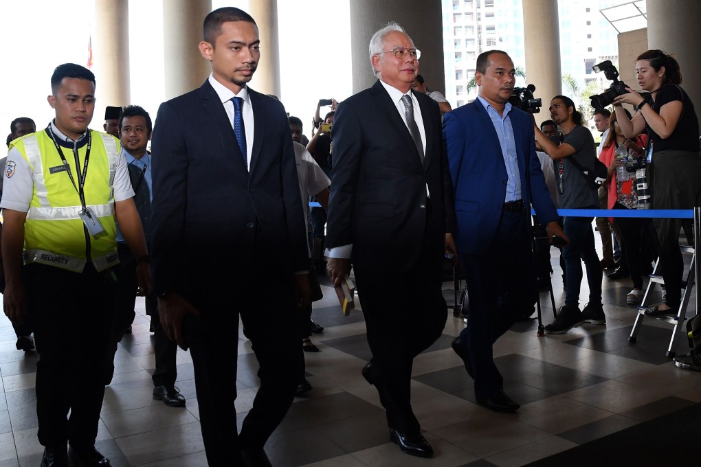 Malaysia's former prime minister Najib Razak (centre) arrives at the Kuala Lumpur High Court for his trial over 1MDB corruption allegations in Kuala Lumpur. Photo: AFP