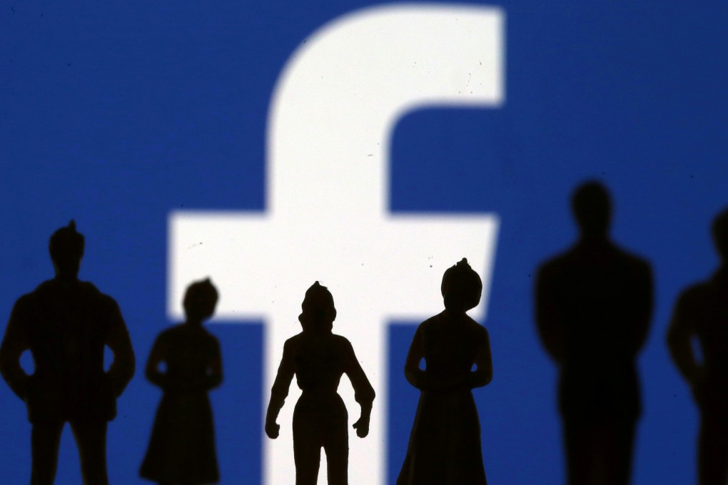 Small toy figures are seen in front of Facebook logo in this illustration picture. Photo: Reuters