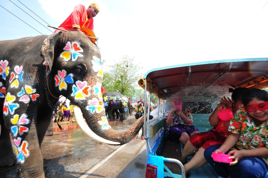 An elephant sprays water on tourists during the Songkran festival, Thailand's traditional New Year Festival, in Ayutthaya. Photo: Xinhua