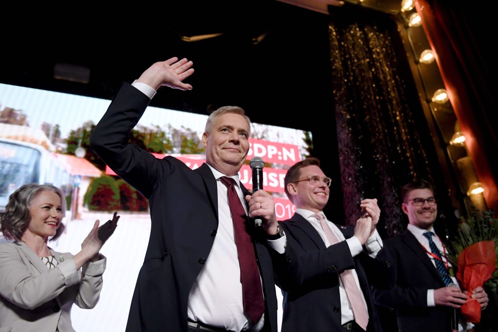 Chairman of the Finnish Social Democratic Party Antti Rinne (centre) his wife Heta Ravolainen-Rinne (left) and Party Secretary Antton Rönnholm (second from right) at their election party in Helsinki. Photo: Agence France-Presse