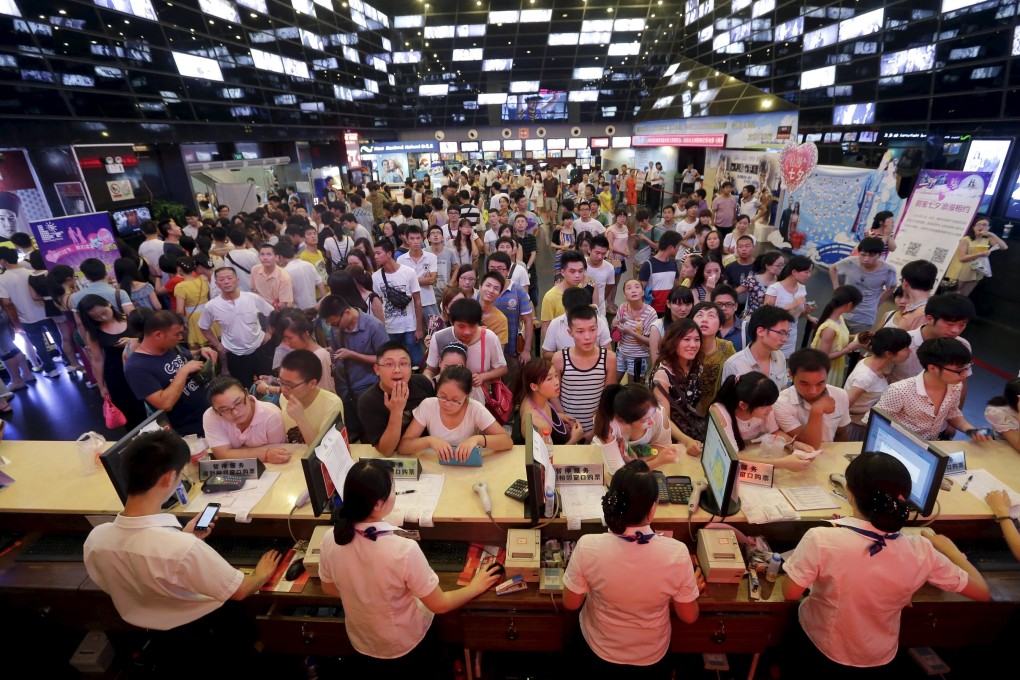 People at the ticket counter at a cinema in Wuhan, Hubei province, on August 13, 2013. Warner Brothers and China Media Capital (CMC) have formed a venture called Flagship Entertainment Group to develop Chinese-language movies, adding to a wave of tie-ups between Hollywood studios and Chinese partners to tap China's fast-growing box office. Photo: Reuters
