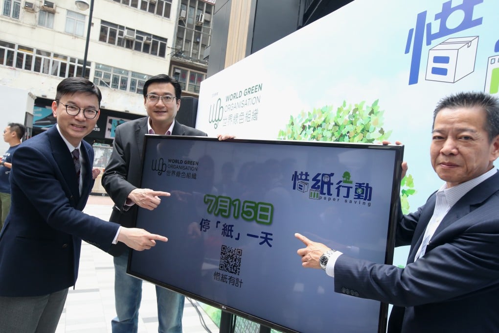 Philip Chan (left) of Canon Hong Kong, William Yu and Clement Lo of BCT Group point to Paper Saving Day, which will be held on July 15. Photo: David Wong