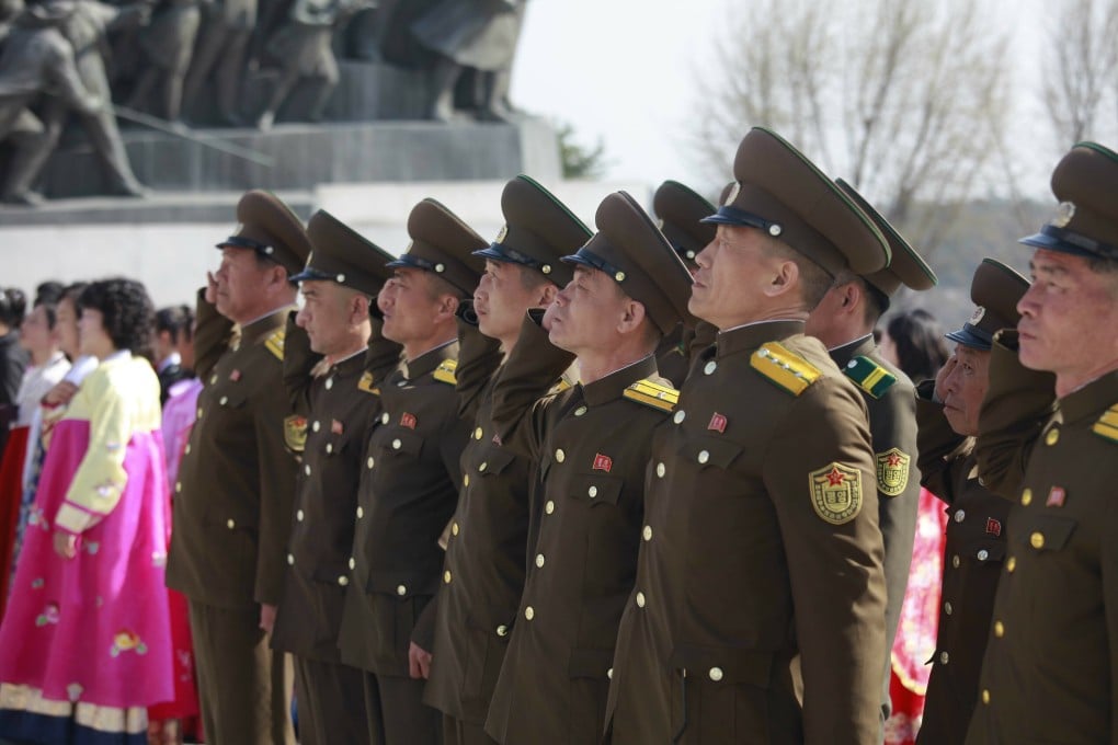 Soldiers pay tribute to the statues of former leaders Kim Il-sung and Kim Jong-il on Mansu Hill to mark the Day of the Sun in Pyongyang. Photo: AP