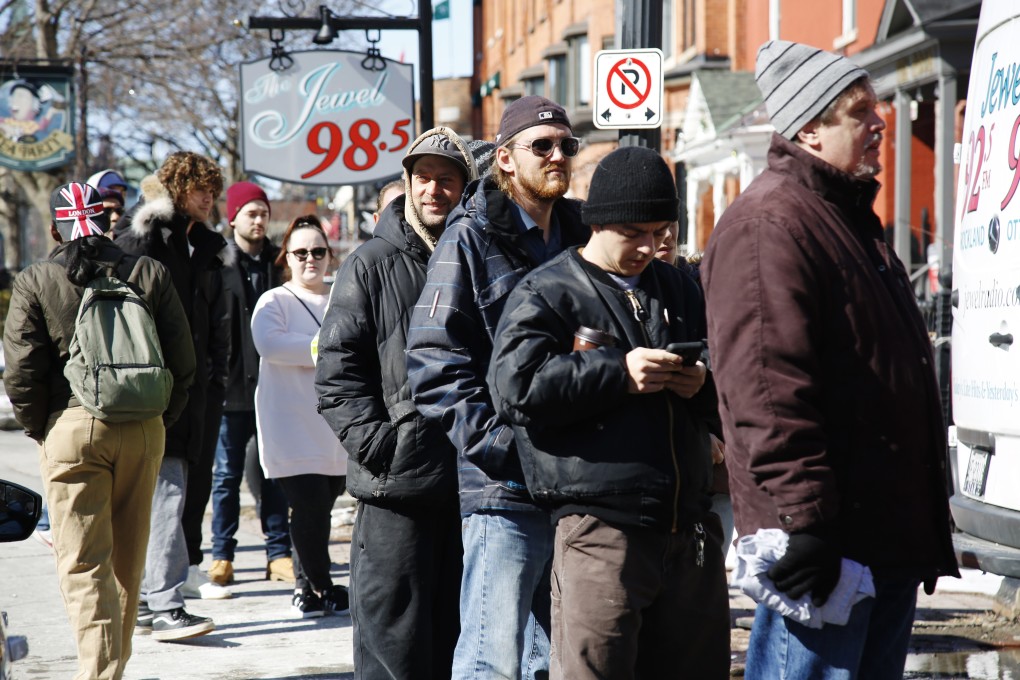 Customers queue up outside a cannabis shop in Ottawa, Canada on Monday, April 1, 2019. Photo: Bloomberg