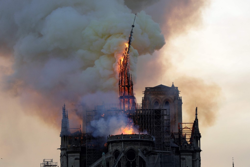 The spire of Notre Dame Cathedral collapses as the cathedral is engulfed in flames on Monday, April 15, 2019. Photo: AFP