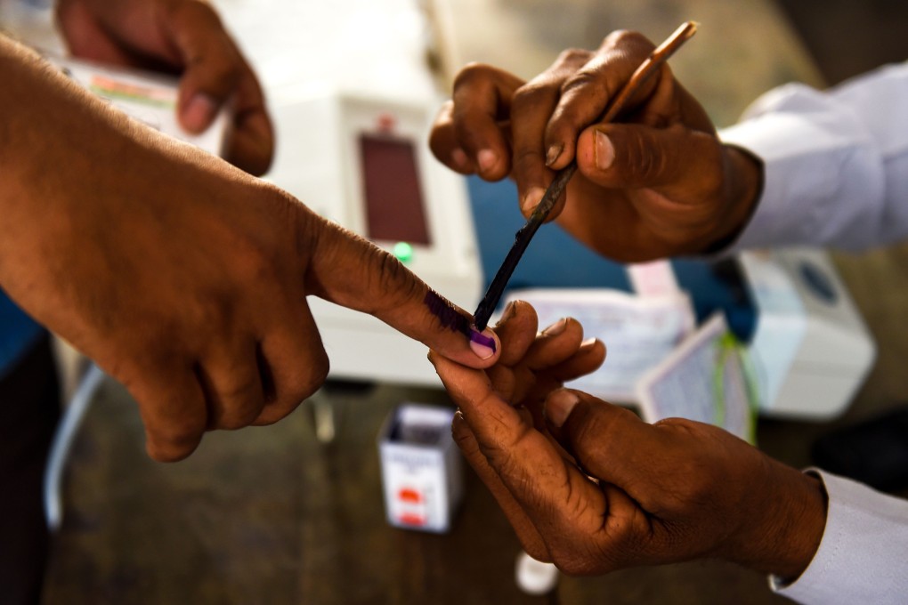 An Indian voter gets her finger marked with ink at a polling station in Uttar Pradesh to show she has voted. Photo: AFP
