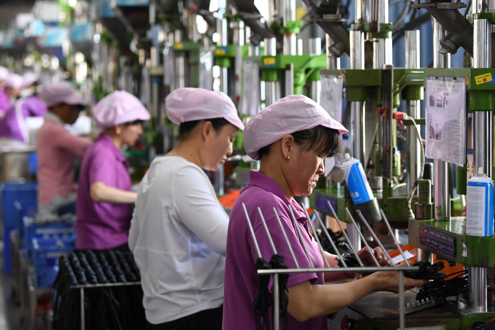 Women work on a data cable production line at a factory in Xinyu, Jiangxi province, China April 8, 2019. Photo: Reuters