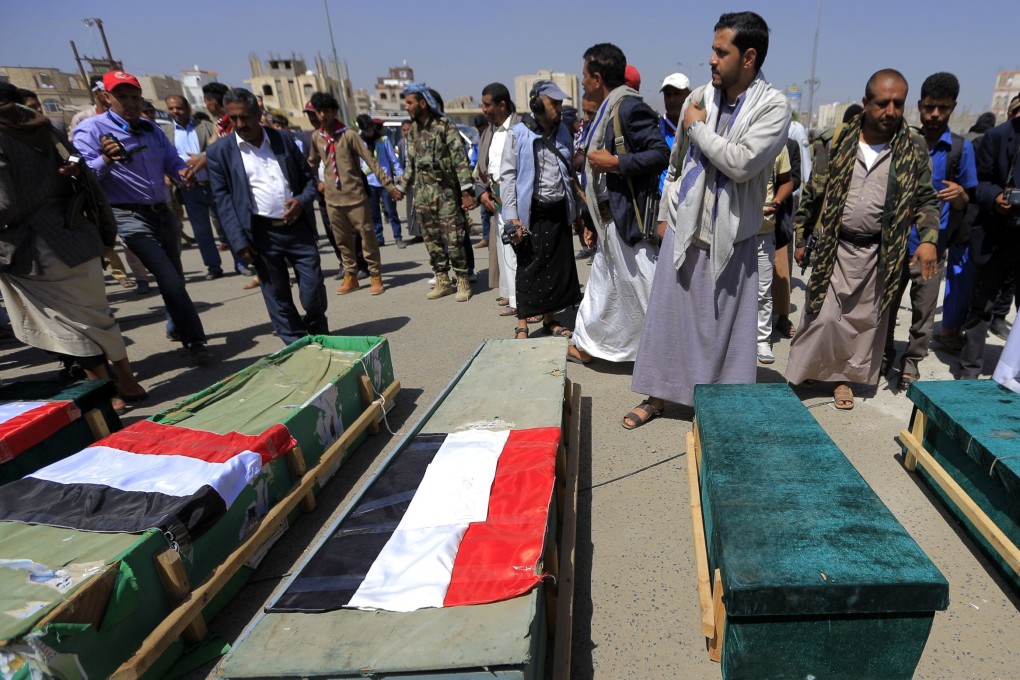 Yemenis gather around the coffins of schoolchildren during a funeral in the capital Sanaa on April 10. Photo: AFP