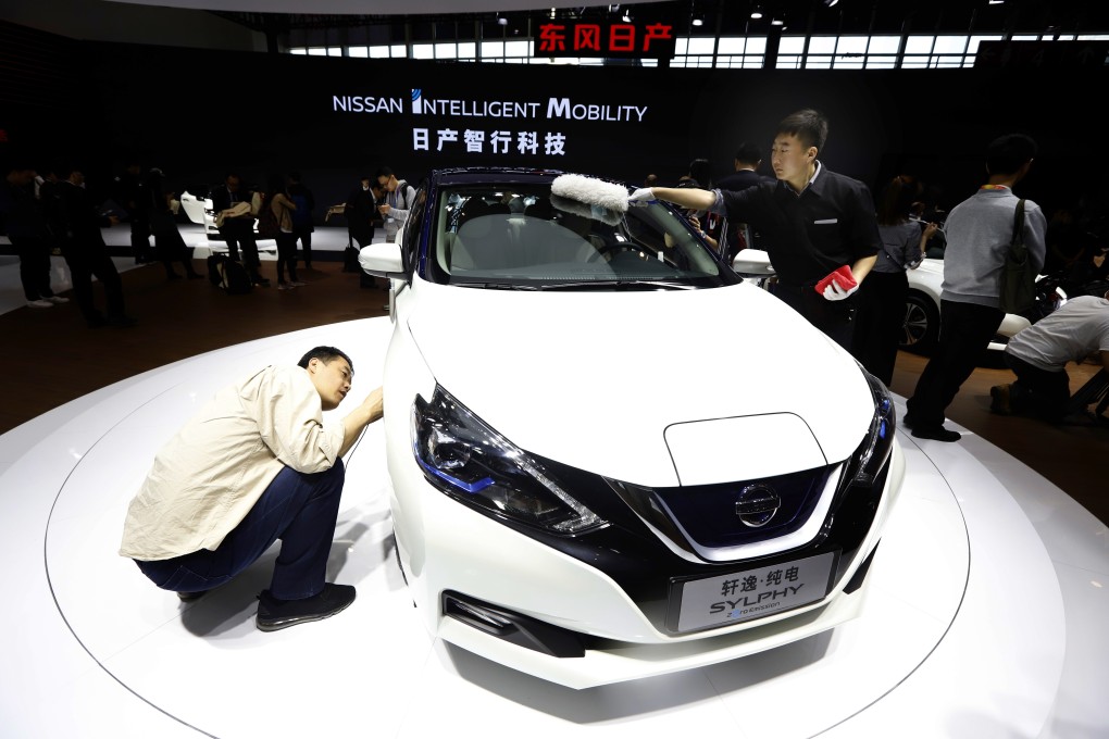 In this file photo from April 25, 2018, a visitor takes a closer look at the Sylphy Zero Emission during the start of Auto China 2018 in Beijing. Nissan and its Chinese partner will display the Sylphy, an all-electric model designed for China that went on sale in August, at the Shanghai auto show. Photo: AP