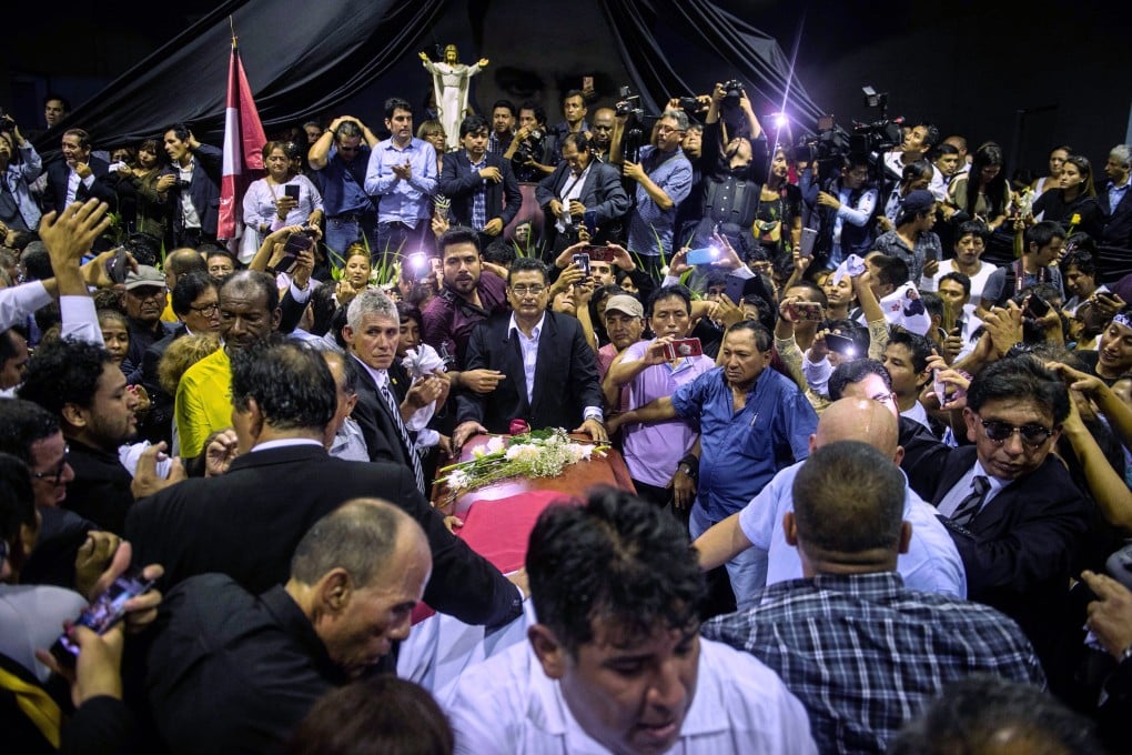 The coffin with the remains of late Peruvian former President Alan Garcia arrives to the American Popular Revolutionary Alliance (APRA) party headquarter's in Lima. Photo: AFP