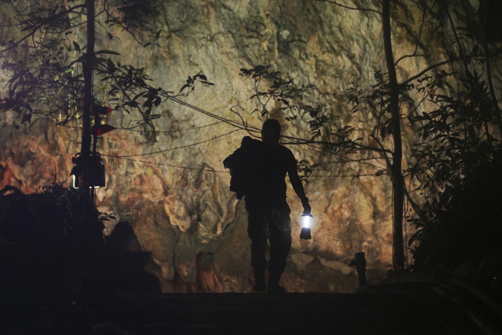 A rescuer makes his way down the entrance to a cave complex where 12 boys and their soccer coach went missing in northern Thailand in July 2018. Photo: AP
