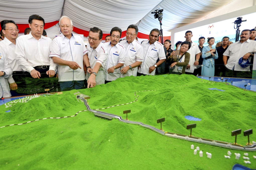 Malaysian officials including former prime minster Najib Razak (third from left) look at a model of the proposed East Coast Rail Link in September 2017. Photo: AP