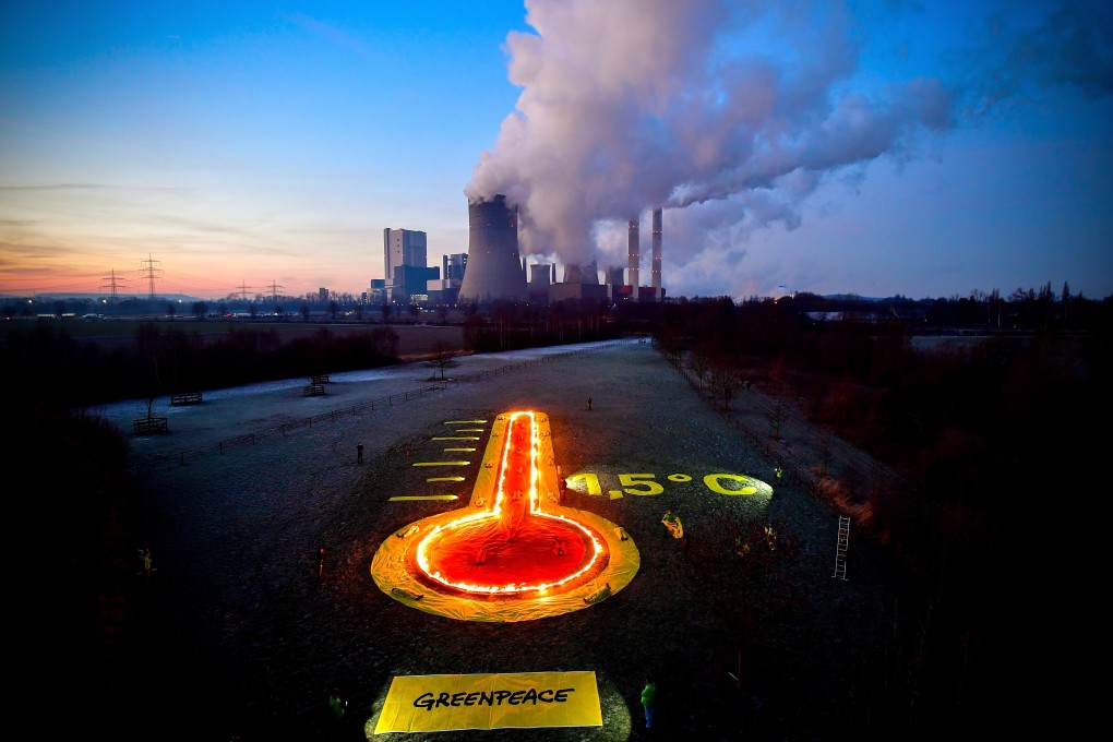 Greenpeace activists display a thermometer installation in front of a brown-coal-fired power plant in Bergheim, Germany, on January 22. The Rhenish Brown Coal Field is Europe’s largest carbon dioxide source. Photo: EPA