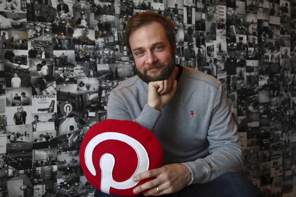 Evan Sharp, Pinterest co-founder and chief product officer, poses for a photo in his office beside a wall of pinned photos he has taken at Pinterest headquarters in San Francisco. Photo: AP