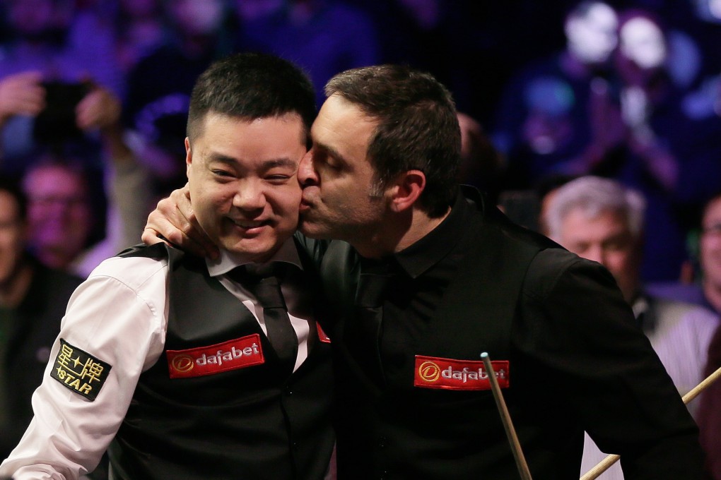 Ding Junhui of China (L) is kissed by Ronnie O'Sullivan of England after their Snooker Masters 2019 meeting in January. Photo: Xinhua