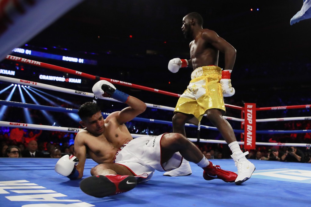 Terence Crawford knocks down Amir Khan. Photo: Reuters