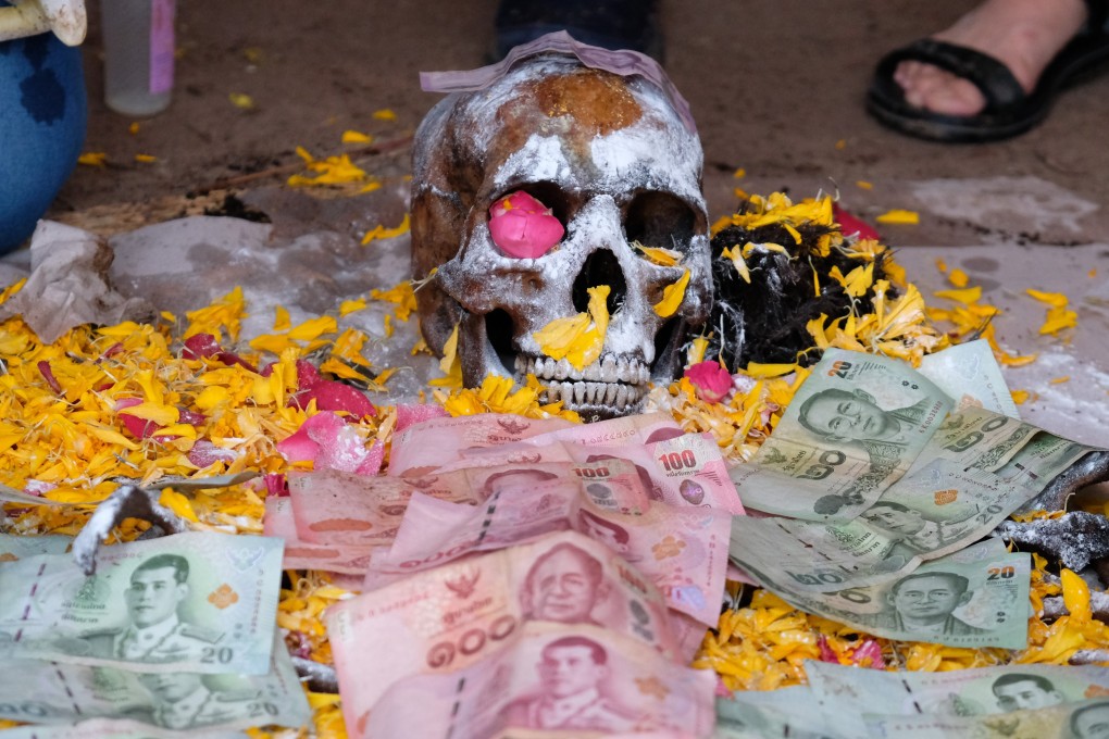 The skull of a newly exhumed skeleton lies on a mat at a small cemetery outside the resort town of Pattaya, in eastern Thailand. Photo: Tibor Krausz