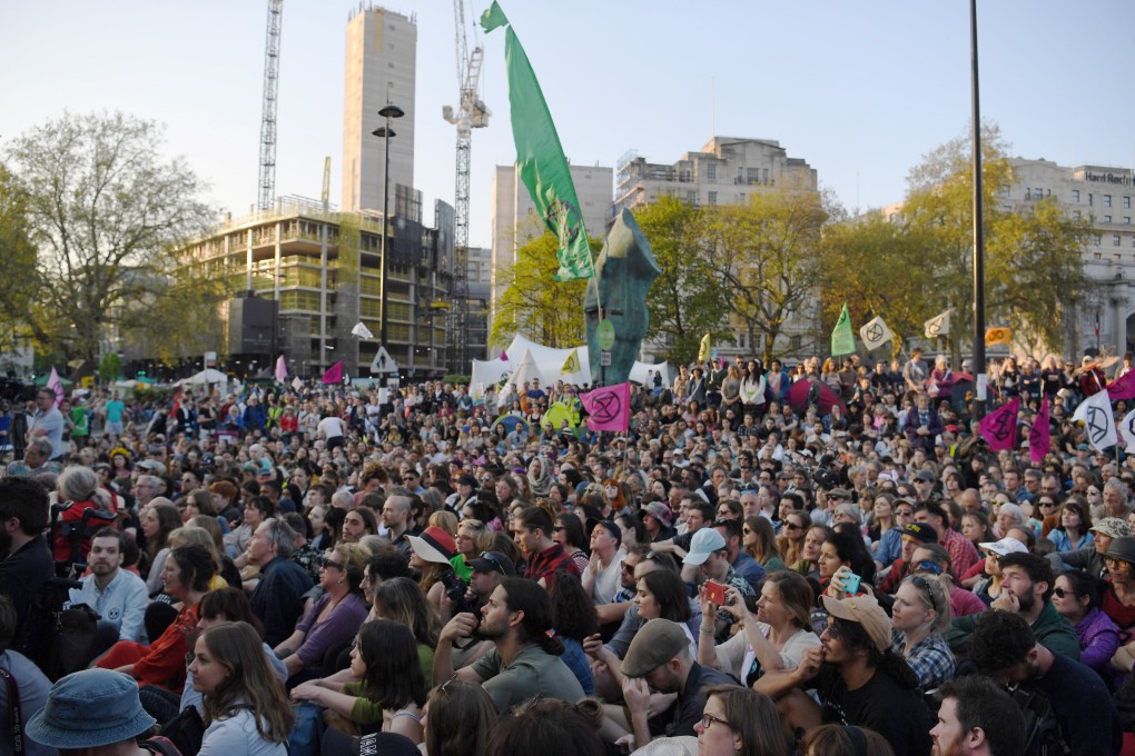 Crowds watch as Swedish schoolgirl climate activist Greta Thunberg speaks during an Extinction Rebellion protest in Marble Arch, central London. Photo: EPA-EFE