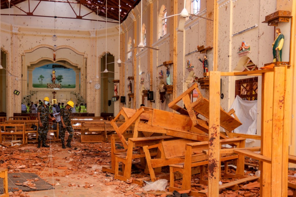 Sri Lankan soldiers inspect damage inside St. Sebastian's Church where a bomb blast took place. Photo: Bloomberg