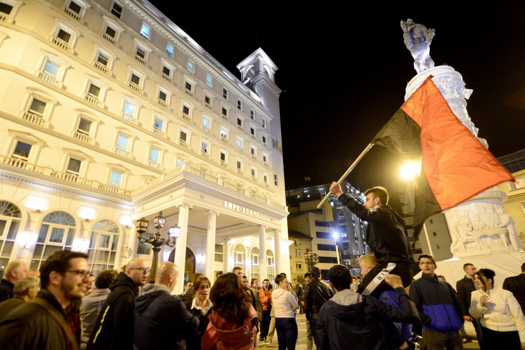 Supporters of opposition party VMRO-DPMNE celebrate the results in the first round of the presidential elections in front of the party headquarters in Skopj. Photo: EPA-EFE