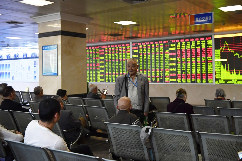 Investors chat in front of an electronic board at a brokerage firm in Chengdu, China on April 19, 2019. Photo: CNA