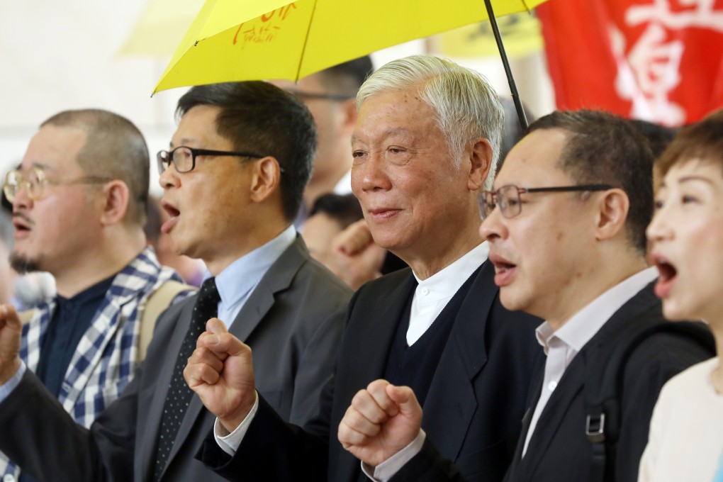 (From left) Lawmaker Shiu Ka-chun, co-founders of the Occupy movement Chan Kin-man, Chu Yiu-ming and Benny Tai Yiu-ting, and lawmaker Tanya Chan chant slogans outside the West Kowloon Court in Sham Shui Po, where they were tried for their participation in the Occupy protests, on April 10. Photo: Sam Tsang