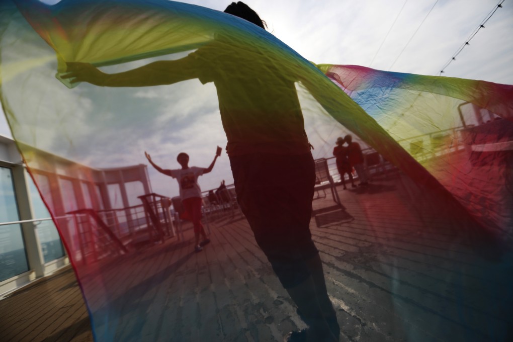 LGBT rights advocates fly the rainbow flag. In Japan, people who are gay often find it difficult to come out. Photo: EPA
