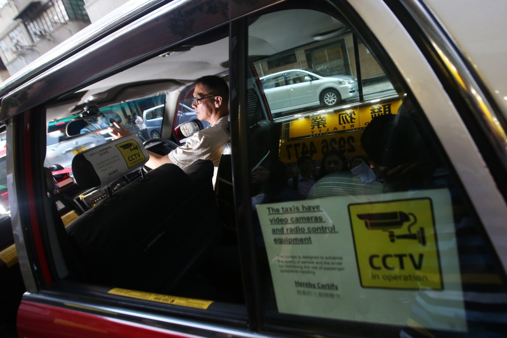 A taxi sports a sticker informing passengers that they could be recorded, as part of a pilot scheme in September 2016. Photo: David Wong
