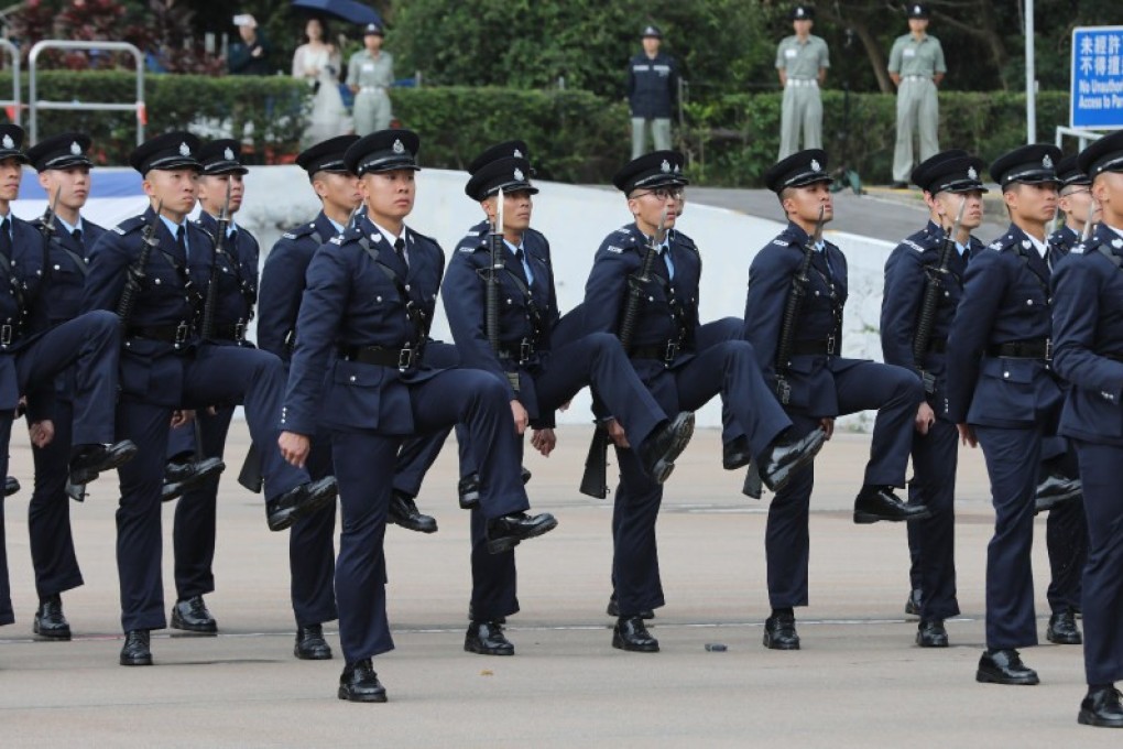 Police officers participate in a passing-out parade of 34 probationary inspectors and 194 recruit constables at the Hong Kong Police College in Wong Chuk Hang, on April 13.