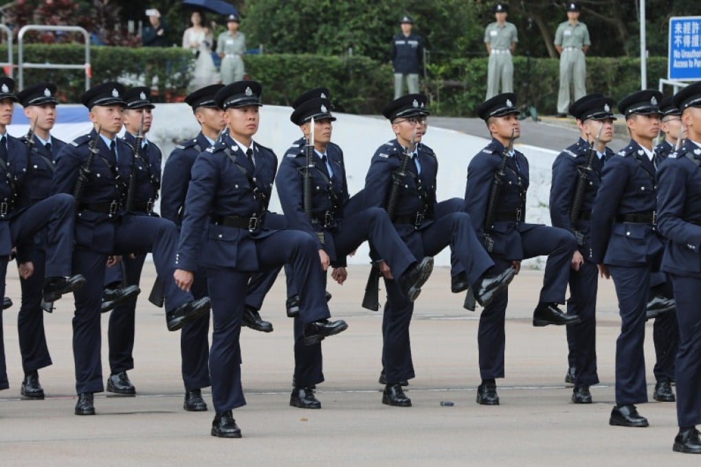 Police officers participate in a passing-out parade of 34 probationary inspectors and 194 recruit constables at the Hong Kong Police College in Wong Chuk Hang, on April 13.