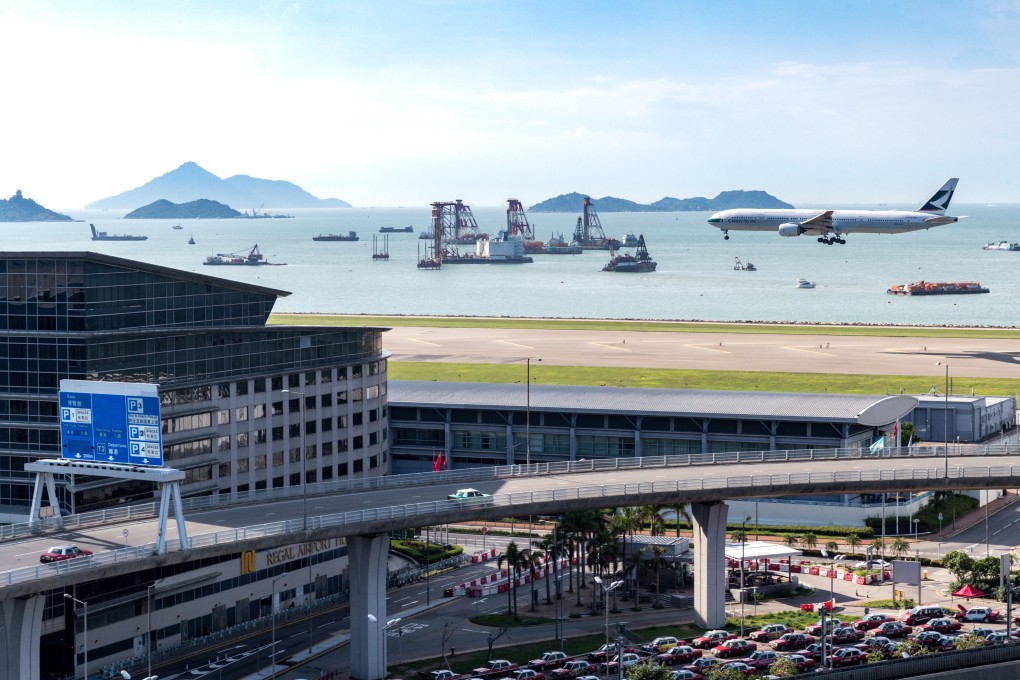 A plane lands at Hong Kong International Airport, which has been so dominant for so long that the idea of competition is inconceivable to some citizens.