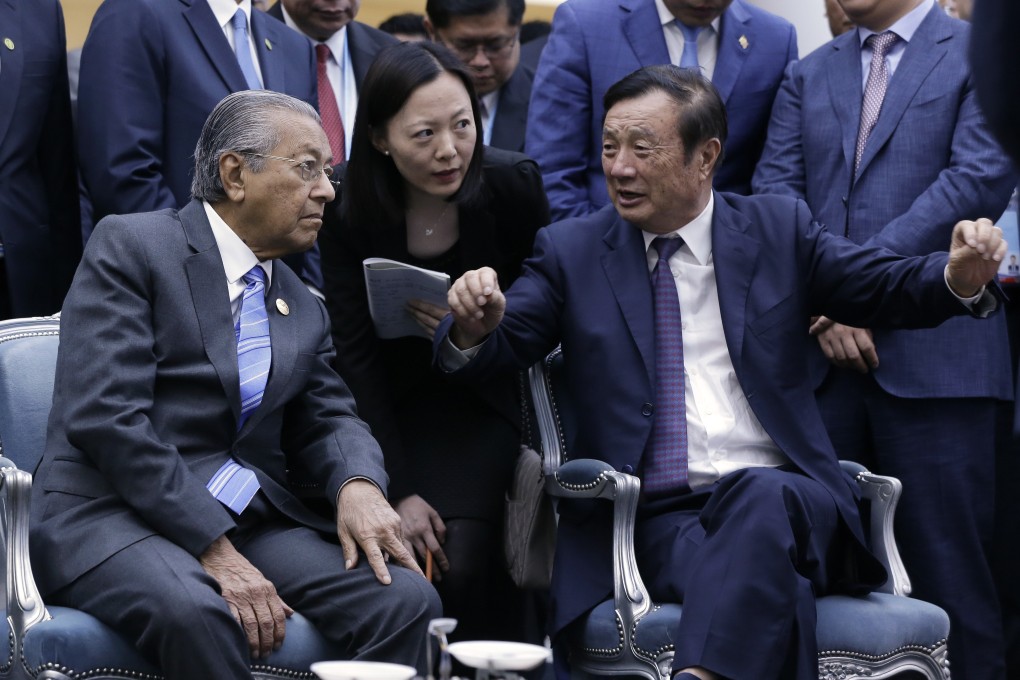 Huawei Technologies founder and chief executive Ren Zhengfei, right, explains the company’s 5G network products to Malaysian Prime Minister Mahathir Mohamad, left, in Beijing on April 25, 2019. Photo: AP