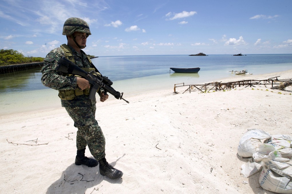 A Filipino soldier patrols on a beach on Thitu Island, which the Philippines calls Pag-asa, in the Spratly group of islands in the South China Sea, west of Palawan, Philippines, in May 2015. Photo: Reuters