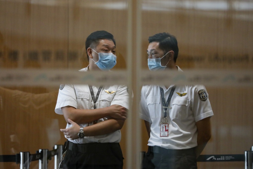 Airport security staff at the Hong Kong International Airport wear face masks during the measles outbreak. Photo: Felix Wong