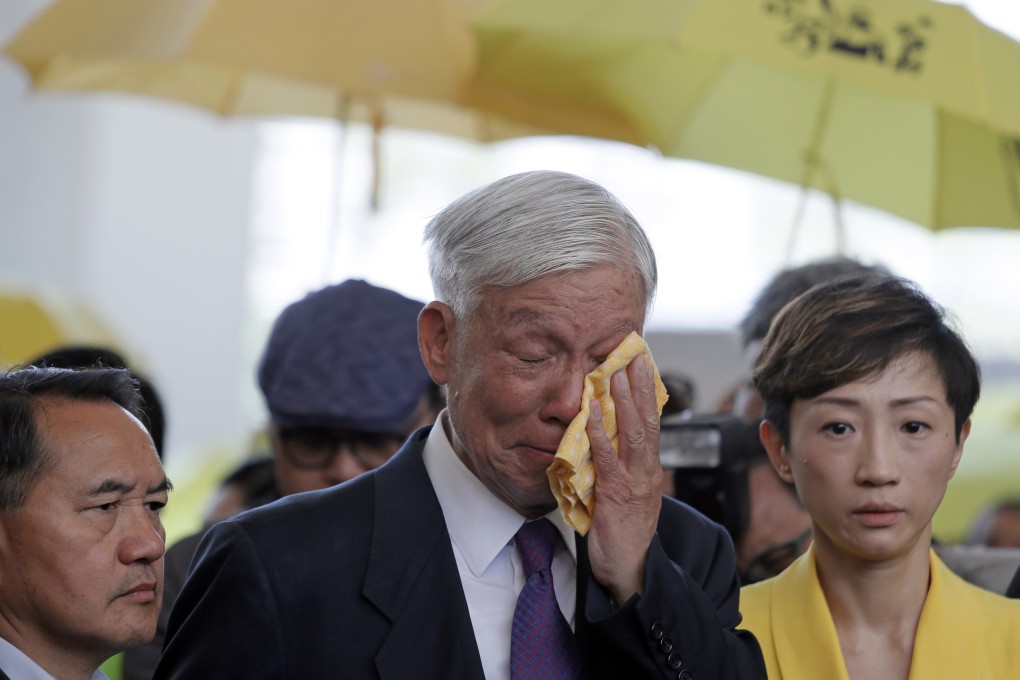 Occupy leader Chu Yiu-ming cries as he speaks to the media after sentencing at a court in Hong Kong on April 24. Eight leaders of massive protests in 2014 were jailed up to 16 months for conspiracy to commit public nuisance. Photo: AP
