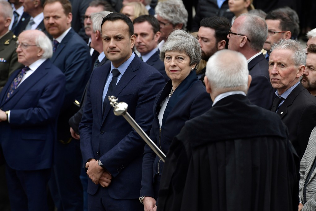 Ireland's President Michael D. Higgins, Prime Minister (Taoiseach) Leo Varadkar and British Prime Minister Theresa May wait as the coffin of murdered journalist Lyra McKee is taken out of the church. Photo: Pool via Reuters