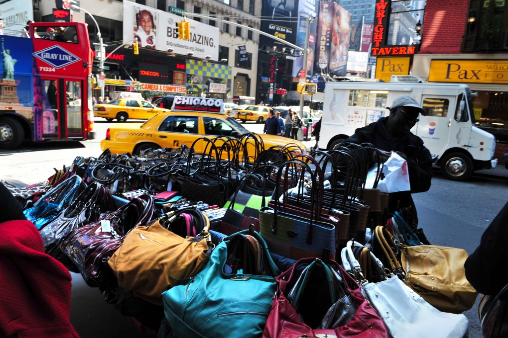 Fake designer handbags for sale in New York, where counterfeit luxury goods from brands like Gucci, Dior, Louis Vuitton and Burberry can all be found for a fraction of the price of the originals. Photo: Alamy