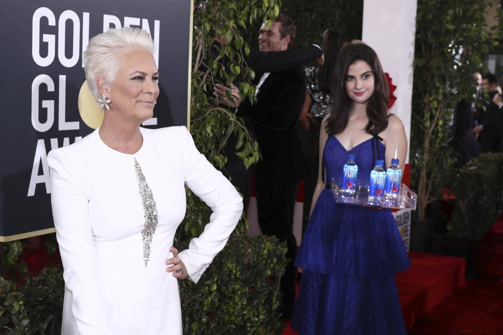 Kelleth Cuthbert (right) in the background as Jamie Lee Curtis (left) poses at Golden Globe Awards red carpet in January. Photo: Invision for Fiji Water via AP