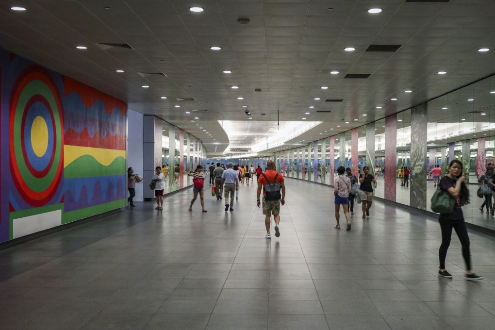 A large wall mural greets commuters walking in an MRT station linking to Marina Bay Sands in Singapore. Photo: Roy Issa