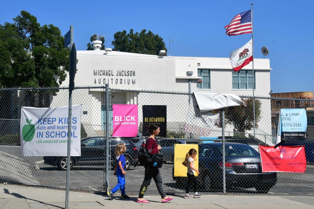 Pedestrians walk past the Michael Jackson Auditorium at Gardner Street Elementary school in Hollywood. Photo: AFP