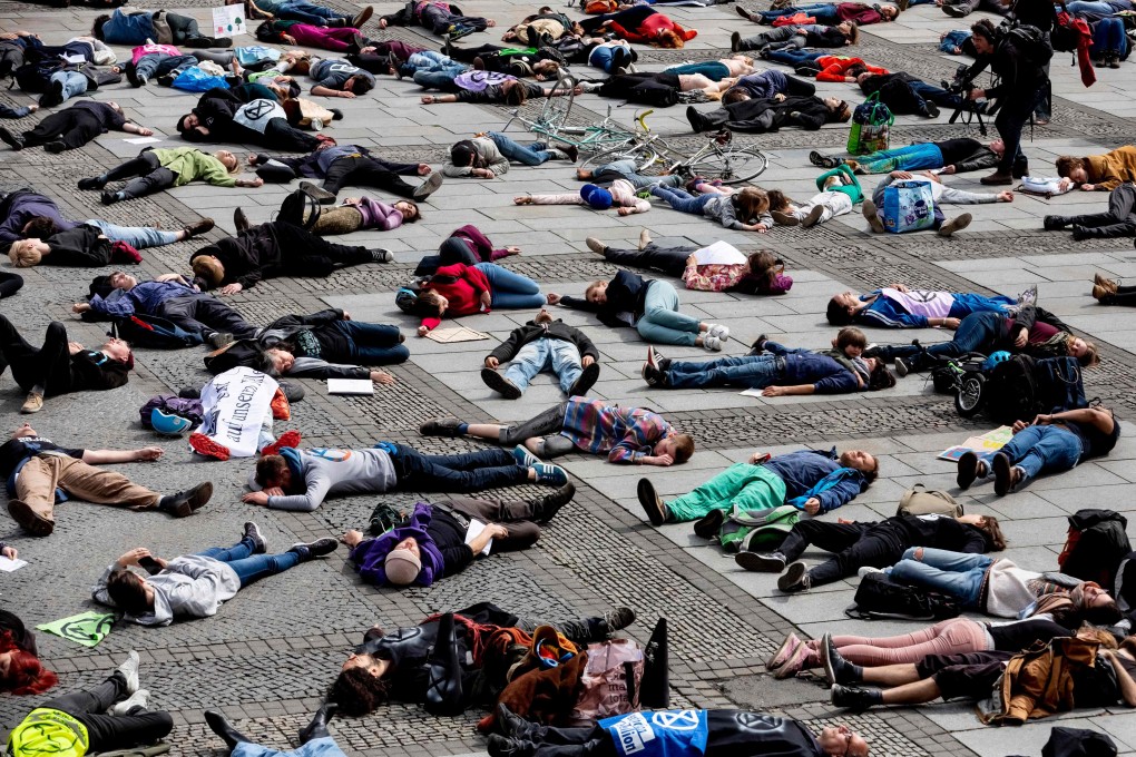 Extinction Rebellion climate change activists lie on the floor to symbolise a "mass die" at the Gendarmenmarkt square in Berlin on April 27. Photo: AFP