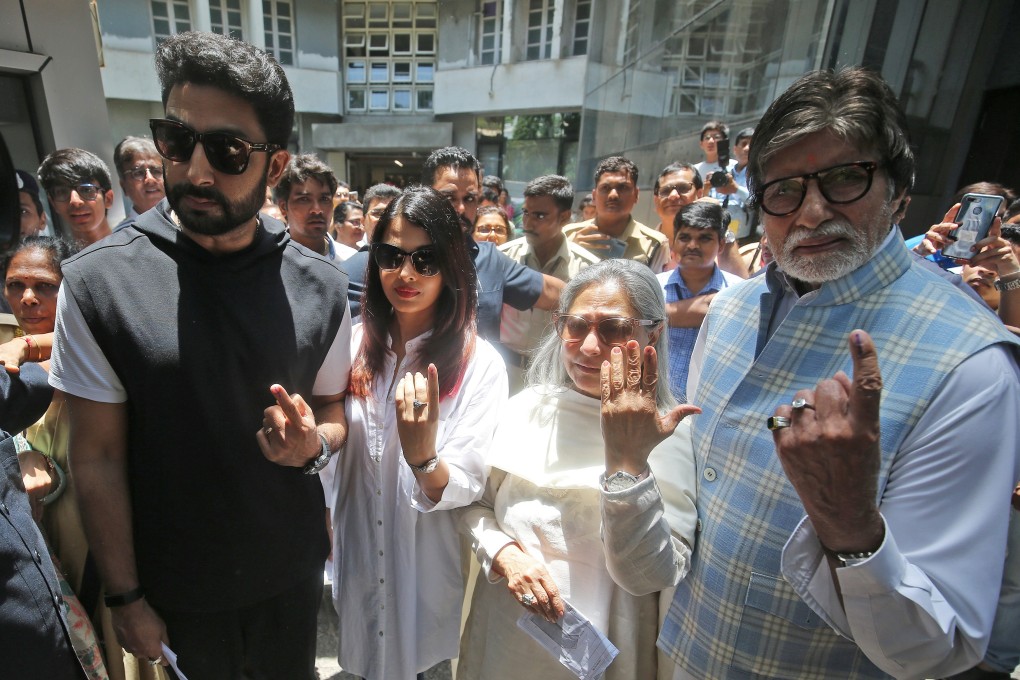 Bollywood star Amitabh Bachchan (right) and family show ink marks on their fingers after casting their votes in Mumbai. Photo: Reuters