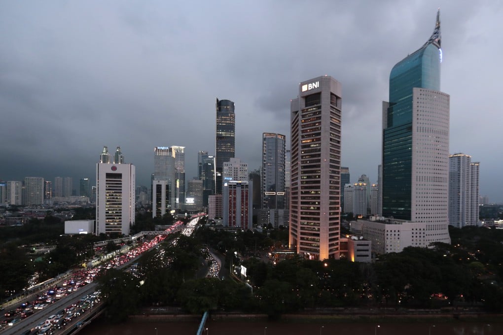 The central business district skyline is seen during the dusk in Jakarta, Indonesia, Monday, April 29, 2019. Indonesia's decades-long discussion about building a new capital has inched forward after President Joko Widodo approved a long-term plan for the government to abandon overcrowded, sinking and polluted Jakarta. (AP Photo/Dita Alangkara)