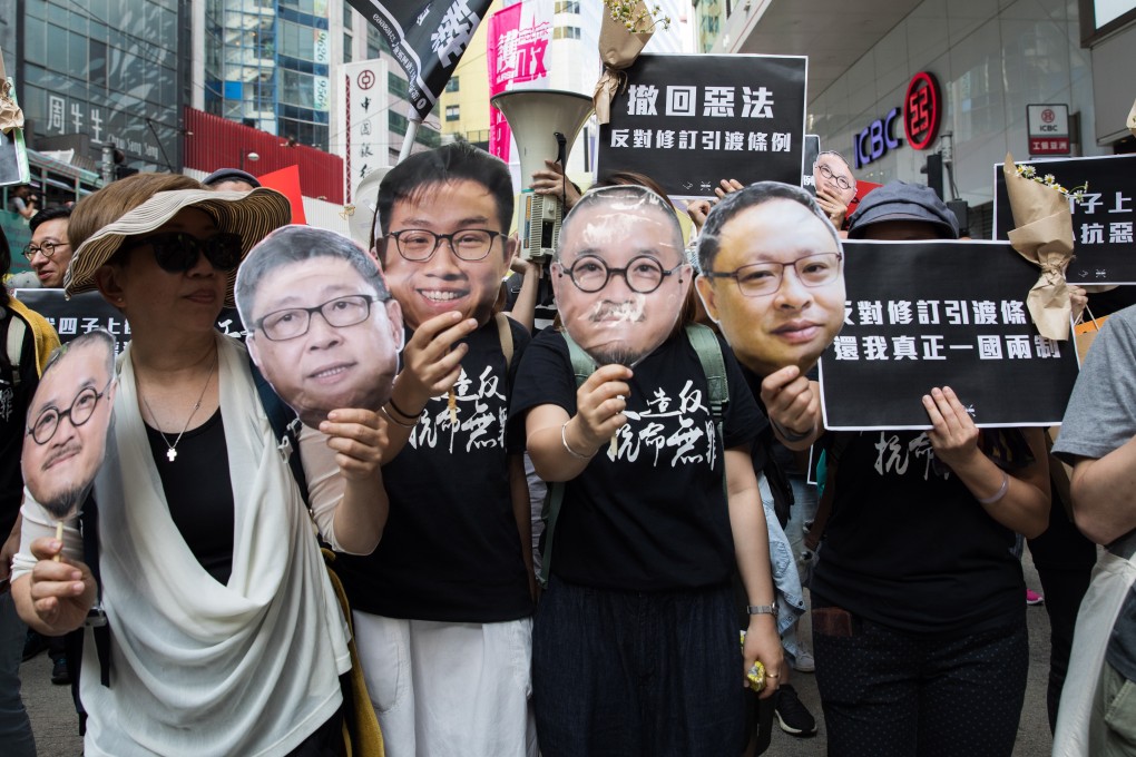 Pro-democracy activists hold masks with faces of jailed Occupy leaders during a march against proposed changes to the extradition law, in Hong Kong on April 28. Photo: EPA-EFE