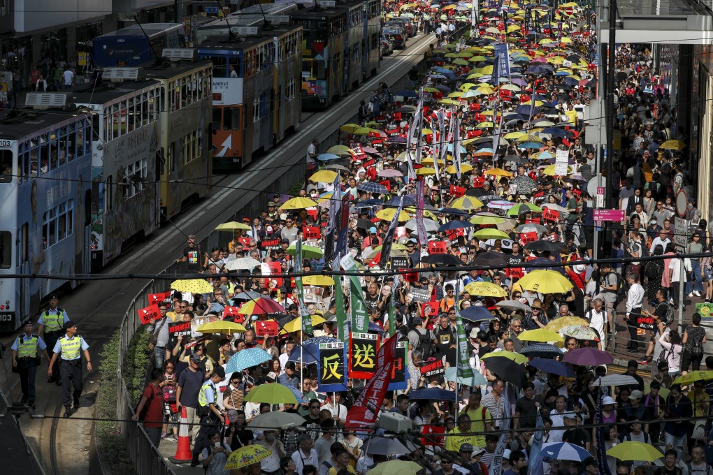 Protesters crowd the streets in Causeway Bay, their sheer numbers creating a queue so long that those at the end of the march have not even moved an hour after the event launched. Photo: Robert Ng