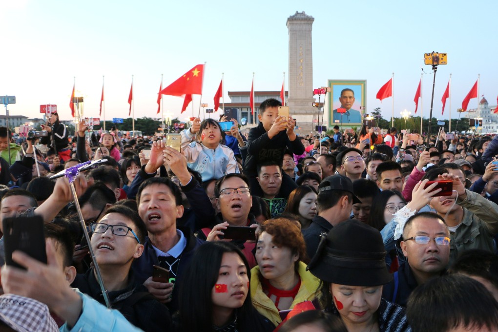 People attend a flag-raising ceremony at sunrise at Tiananmen Square on Chinese National Day in Beijing on October 1, 2018. Photo: Reuters