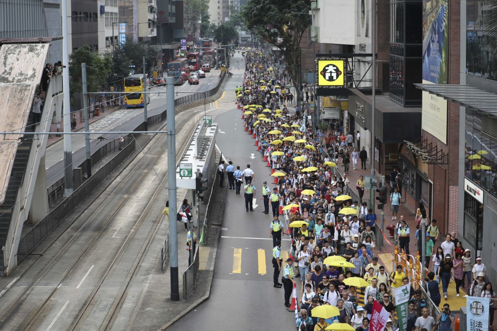 Protesters marching in Causeway Bay on Sunday. Photo: James Wendlinger