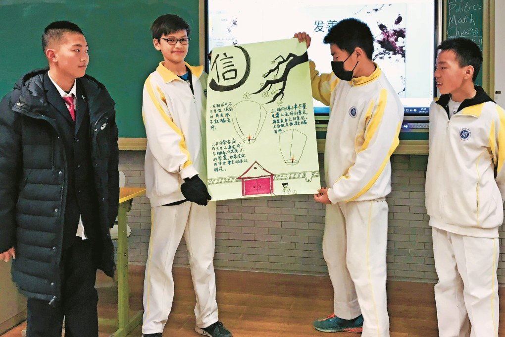 Trey Crawford (second left) displays a school project with other pupils at the high school affiliated to the University of Science Technology Beijing, China. Photo: Handout