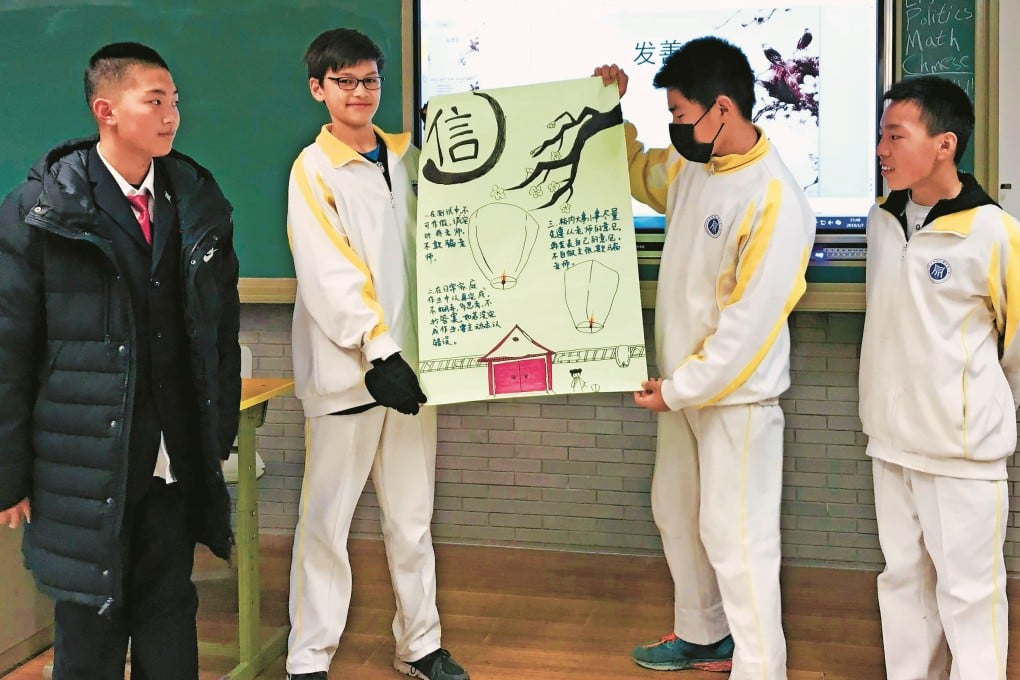 Trey Crawford (second left) displays a school project with other pupils at the high school affiliated to the University of Science Technology Beijing, China. Photo: Handout